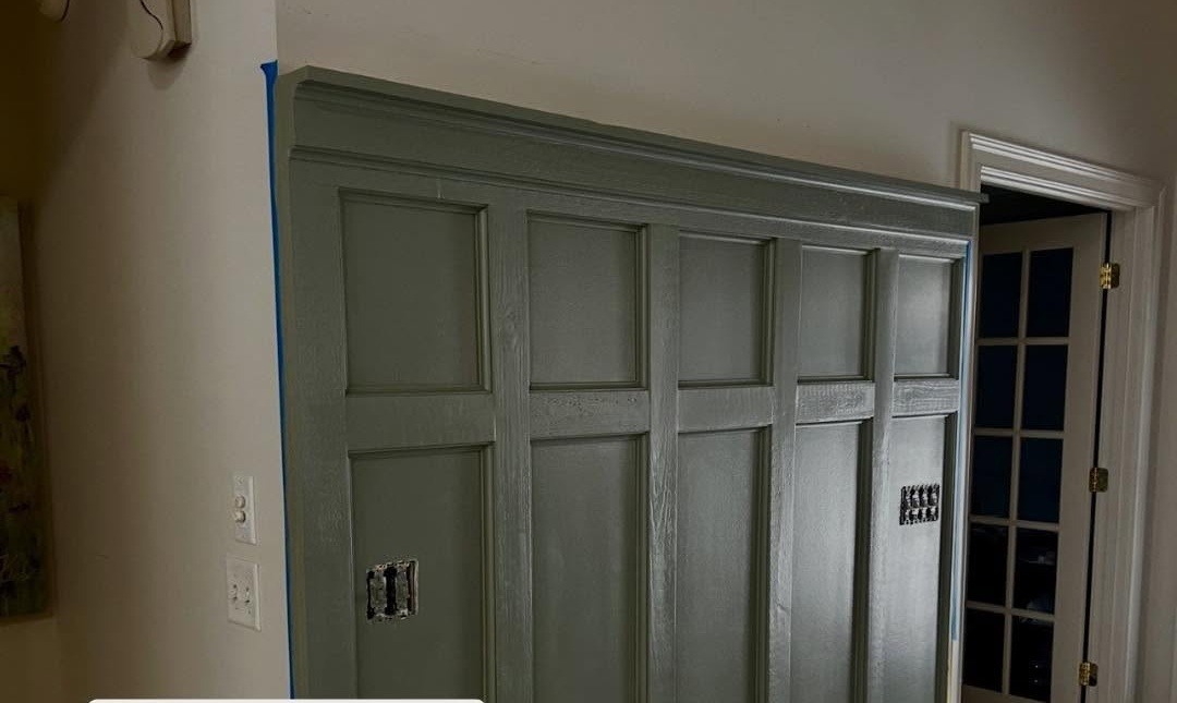 Board and batten accent wall painted sage green by A Ray of Color, tape still up