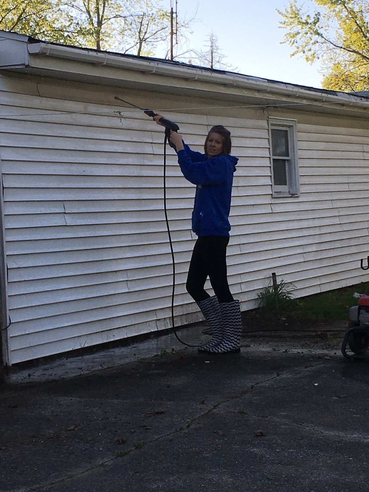 Power washing house siding before an exterior repaint