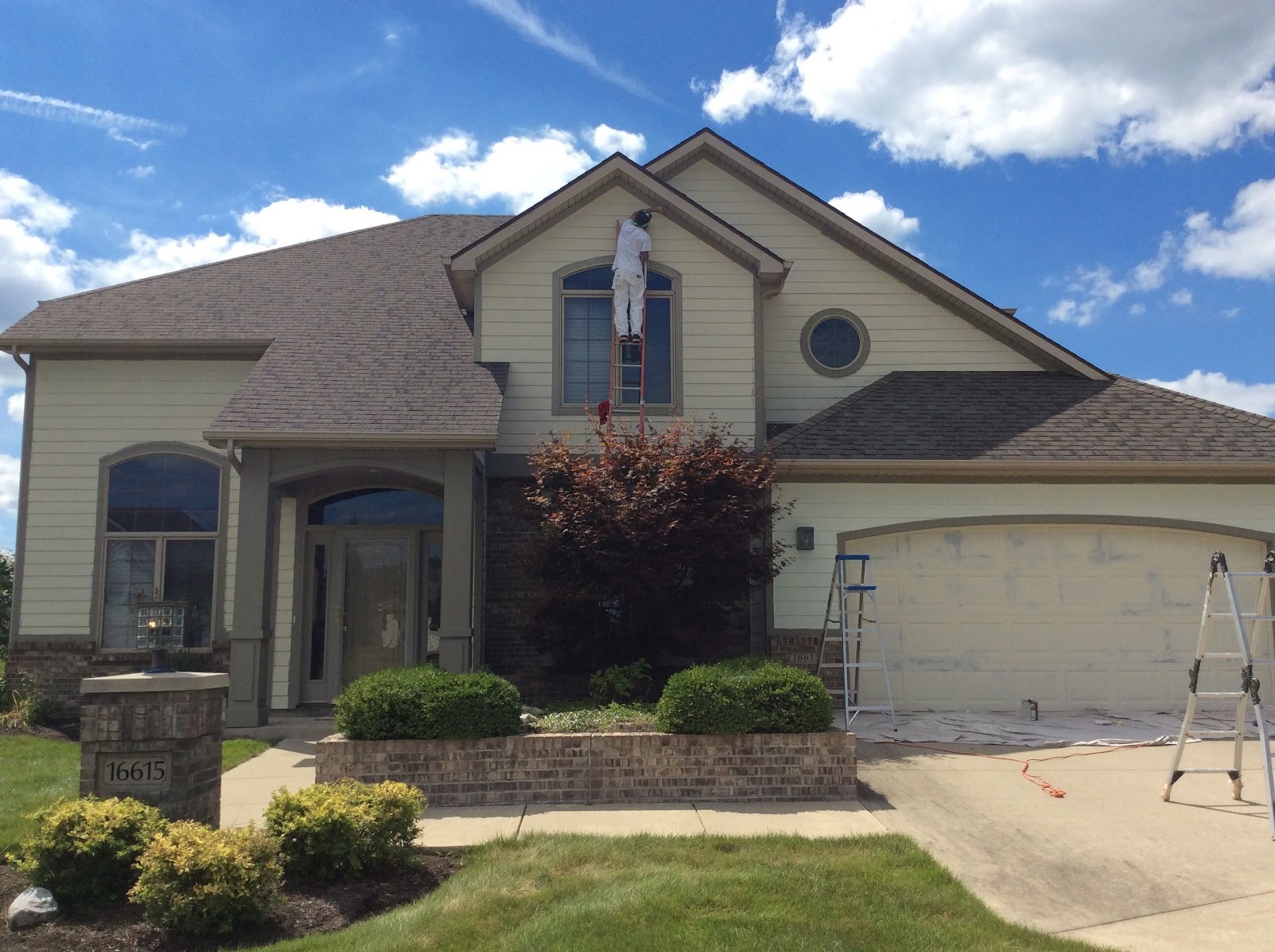 A Ray of Color repainting a two-storey home in Fort Wayne, Indiana
